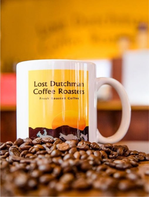 Lost Dutchman Coffee Roasters Cup Between Roasted Coffee Beans